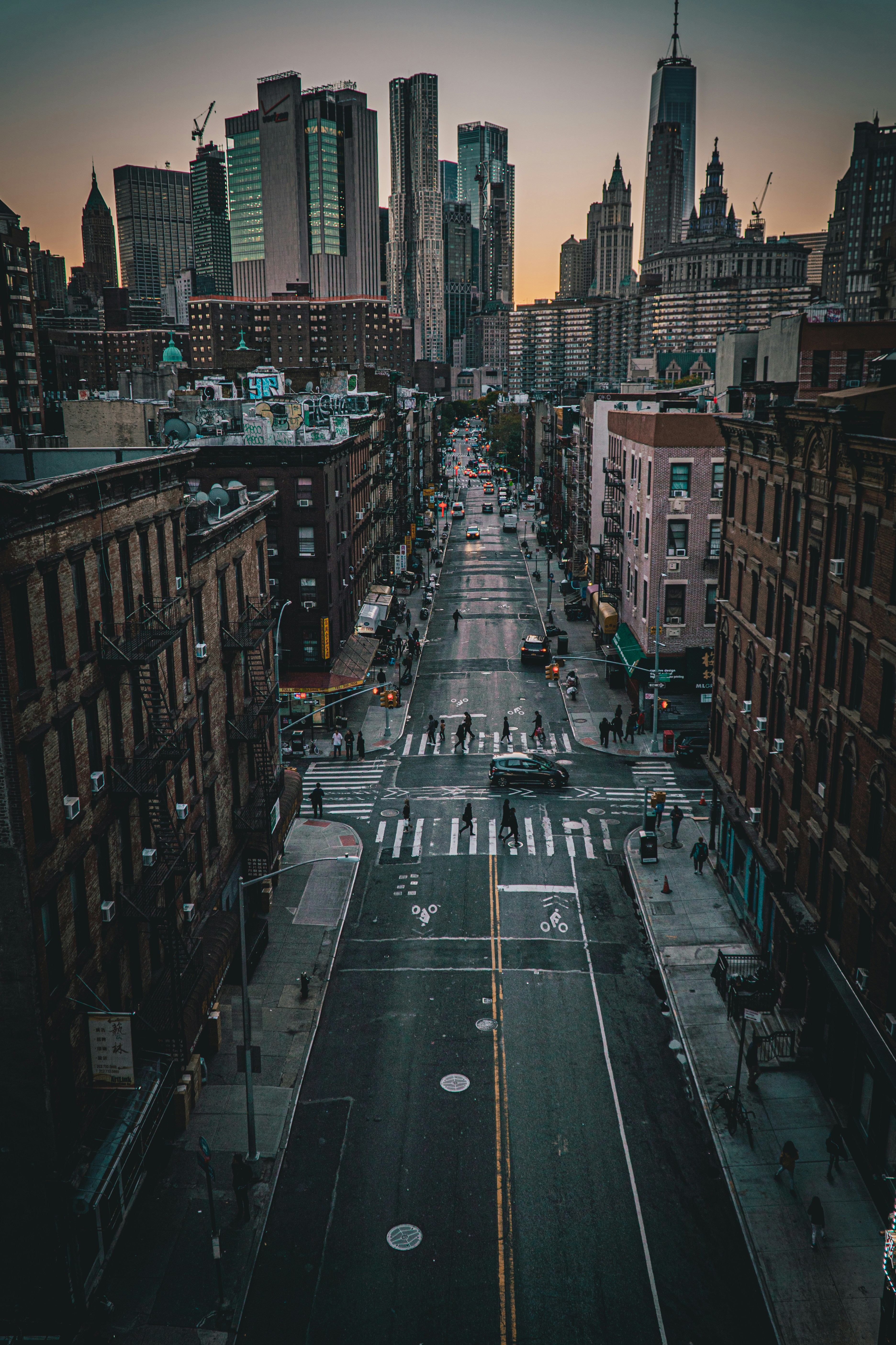 Empty lower Manhattan street at dusk — the city as a threshold between the visible world and something else